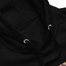 Load image into Gallery viewer, Close-up of a black hoodie with a brand logo on a white background