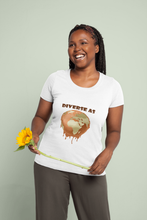 Load image into Gallery viewer, Woman wearing a wearing a black t-shirt with a Earth melting design and text "Diverse as Earth" standing outdoors. holding a sunflower against a light green background.