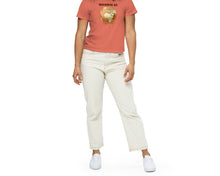 Load image into Gallery viewer, Young woman wearing a coral t-shirt with a graphic design of Earth melting and text "DIVERSE AS" on a white background