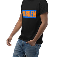 Load image into Gallery viewer, Man wearing a black t-shirt with a graphic design on a white background