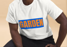 Load image into Gallery viewer, Man wearing a white t-shirt with 'GARDEN' printed on it against a beige background