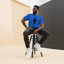 Load image into Gallery viewer, A man wearing a royal blue crew neck t-shirt with a black graphic of an afro pick on the front.