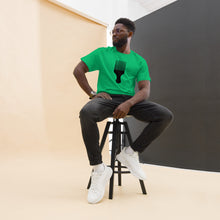 Load image into Gallery viewer, A man wearing a Irish green crew neck t-shirt with a black graphic of an afro pick on the front.