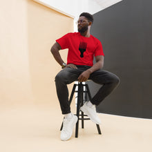 Load image into Gallery viewer, A man wearing a red crew neck t-shirt with a black graphic of an afro pick on the front.