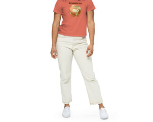 Young woman wearing a coral t-shirt with a graphic design of Earth melting and text "DIVERSE AS" on a white background