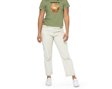 Load image into Gallery viewer, Woman  wearing a green t-shirt with a Earth melting design and text &quot;Diverse as Earth&quot; standing outdoors.
