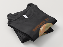 Load image into Gallery viewer, Folded black t-shirt with &#39;DIVERSE AS&#39; text and graphic on a light gray background
