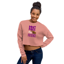 Load image into Gallery viewer, Woman wearing a mauve cropped sweatshirt with text, &#39;DON&quot;T POKE MY PATIENCE&#39; and graphic hand design.
