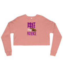 Load image into Gallery viewer, Pink long-sleeve crop top with purple text, &#39;DON&quot;T POKE MY PATIENCE&#39; and brown hand graphic on a white background
