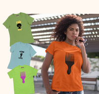 Woman wearing an orange t-shirt with a black Pick design, surrounded by other t-shirts with similar designs.