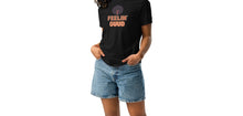 Load image into Gallery viewer, Woman wearing a black t-shirt with &#39;FEELIN&#39; GUD&#39; text and denim shorts on a white background
