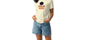 A woman wearing a pale yellow t-shirt with text, 'FEELIN GUUD with fluffy afro design on a white background