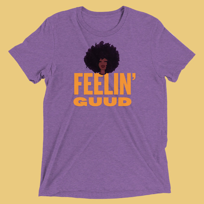 Radiate good energy in the Feelin’ Guud tee —soft, joyful, and stylish essentials that keep your vibe lifted all day. Purple t-shirt with 'Feelin' Guud' text and graphic.