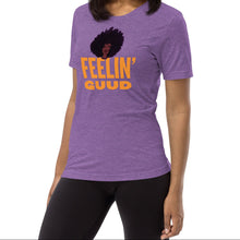 Load image into Gallery viewer, Radiate good energy in the Feelin’ Guud tee—soft, joyful, and stylish essentials that keep your vibe lifted all day. Woman wearing a purple t-shirt with &#39;FEELIN&#39; GUUD&#39; text and graphic.
