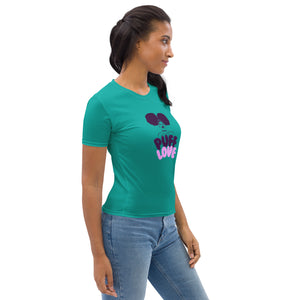 Woman wearing a teal t-shirt with a graphic design on a white background