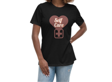 Load image into Gallery viewer, Woman wearing a black t-shirt with &#39;Self Care&#39; design on a white background
