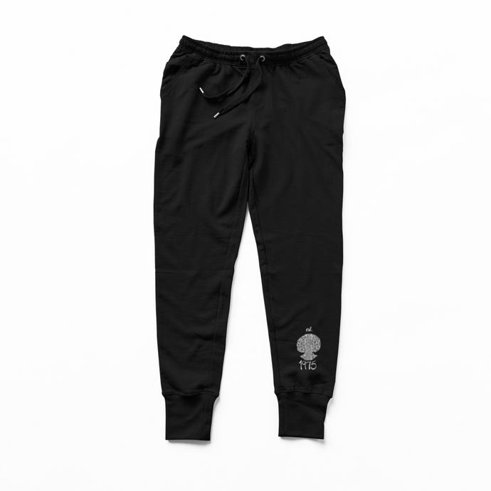 Black jogger pants with a est. 1975 leopard print Shiluette on a white background